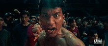 a man in a boxing ring with kahar written on the bottom right