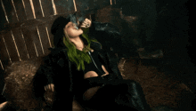 a woman with green hair smoking a cigarette
