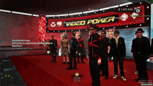 a group of men stand in front of a video poker sign