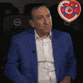 a man in a blue jacket is sitting in a theater
