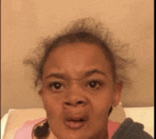 a close up of a woman 's face with a surprised look on her face .