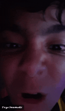 a close up of a person 's face with the name toge inumaki on the bottom right