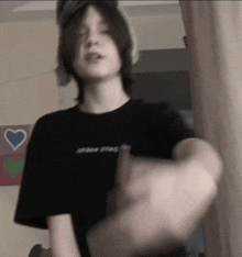 a young man wearing a black shirt that says ' game over '