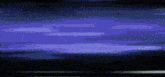 a person is holding a sword in a dark room and a yellow light is coming out of it .