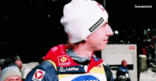 a man wearing a beanie that says giesswein on the front
