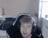 a man wearing headphones is sitting in a chair in a room .