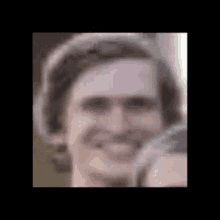 a close up of a man 's face with a hat on and smiling .