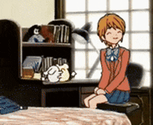 a girl is sitting on a chair in front of a desk in a room