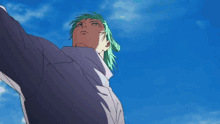 a man with green hair is looking up at a star