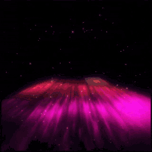 a purple and red light coming out of a black hole