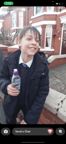 a phone screen shows a boy holding a bottle of water and says send a chat