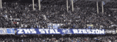 a crowd of people in a stadium holding a banner that says zks stal rzeszow