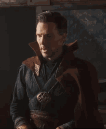 a close up of a doctor strange wearing a necklace