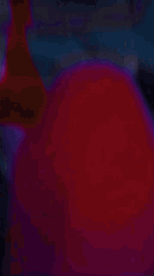 a blurry picture of a purple and red colored item