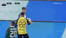 a soccer player wearing a yellow jersey with the number 22 on it