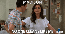 a man and a woman are standing in front of a refrigerator with the woman saying madison no one cleans like me netflix