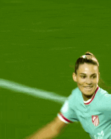 a blurred image of a female soccer player wearing a shirt that says ' sky ' on the front