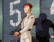 a man holding a gun in front of a wall with the number 5