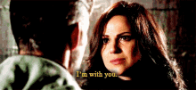 a man and a woman are looking at each other and the woman is saying i 'm with you