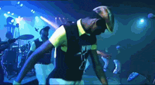 a man in a black shirt that says ' n.w. ' on it is dancing on a stage