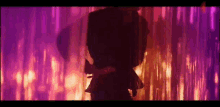 a silhouette of a person standing in front of a purple curtain with a purple background .