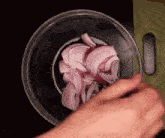 a person is cutting an onion in a bowl with a knife