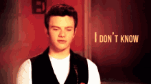 a man says i don 't know in front of a red door