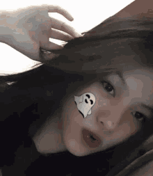 a girl with a ghost on her cheek