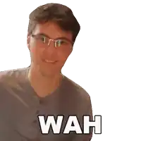 a man wearing glasses and a grey shirt with wah written on it