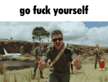 a man in a military uniform stands in a field with the words go fuck yourself written above him