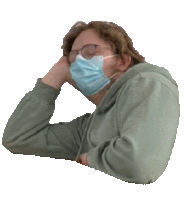 a man wearing a face mask and glasses looks tired