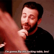 a man with a beard is saying i 'm gonna flip this fucking table bro