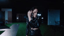 a group of people are standing around a man in a black leather jacket