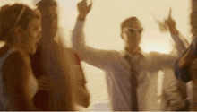 a group of people are dancing together in a room .