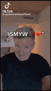 gordon ramsay is making a funny face with a broken heart in the background