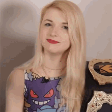 a woman wearing a purple shirt with a monster on it