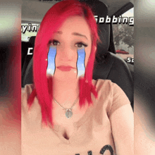 a woman with red hair is sitting in a car with the word robbing on the back seat