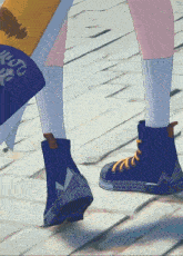 a close up of a person 's feet wearing a pair of blue boots