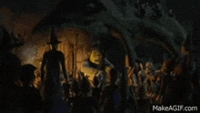 shrek is standing in front of a crowd of people .