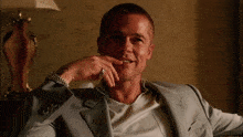 a man in a suit has a watch on his left wrist