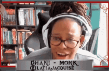 a woman wearing headphones and glasses has the name dhani monk written on a sign