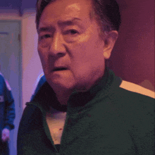 a man wearing a green jacket with the number 43 on the back