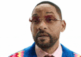 a man wearing sunglasses and a colorful sweater
