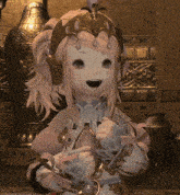a little girl with a crown on her head is holding a flower