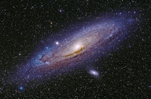 a spiral galaxy in the middle of a galaxy in the night sky .