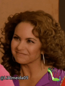 a woman with curly hair is smiling and has the hashtag @ lialmeida05