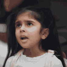 a little girl with a white shirt that says ' amanda ' on it