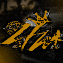 a black and yellow logo with a crown and a diamond