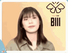a woman in a green jacket is making a funny face in front of a yellow background .