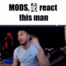 a man in a blue shirt is sitting in front of a computer screen .